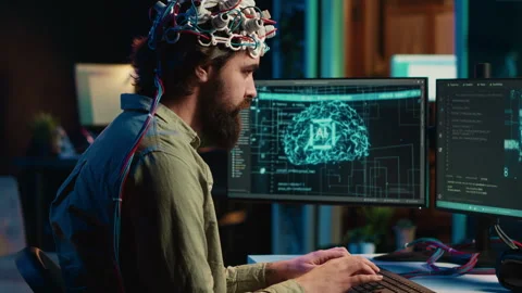 IT admin coding and using EEG headset to upload brain into computer Stock Footage 266954291