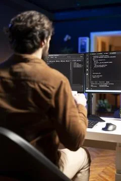 IT admin inspecting coding on desktop PC, looking to fix potential issues Stock Photos