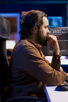 IT admin working on computer, preventing malware and phishing attacks Stock Photos