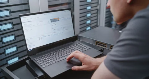 IT Administrator Analyzing Server Logs and Hardware Status Beside Network Switch 動画素材 344956945