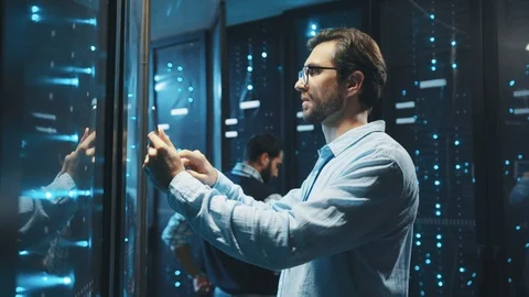 IT administrator checking system quality of server cabinets working on rack Stock Footage 119279152