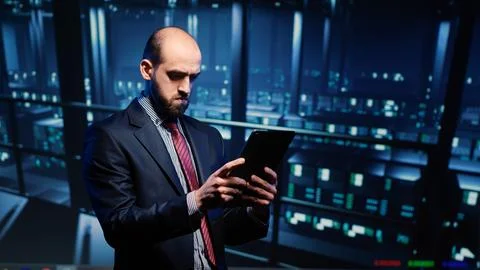IT administrator running security diagnostics on tablet 스톡 사진