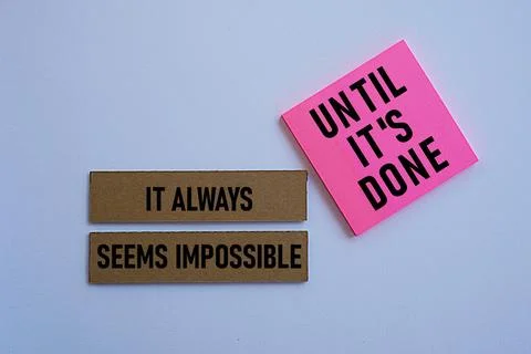 IT ALWAYS SEEMS IMPOSSIBLE UNTIL IT'S DONE, Motivational quotes Stock Photos