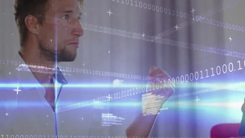 IT analyst referencing data gesturing palm pointing toward binary streams Stock Footage 327786395