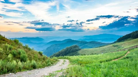 It becomes gradually darker flowing through a mountain ridge above the clouds. Video stock 145743621