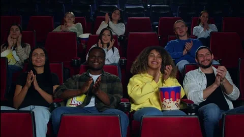 It is a blast. The audience applauds after watching the premiere of a new film Stockbeeldmateriaal 267351138
