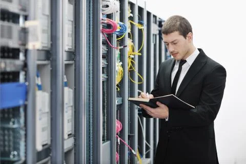 It businessman withnotebook in network server room Stock Photos