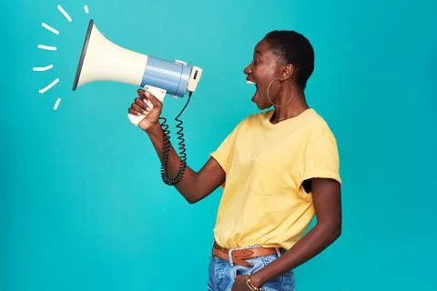 It can take one voice to change the world. Studio shot of a young woman using 스톡 사진