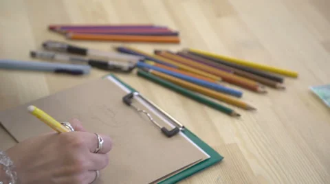 It is close-up image of artist hand, workplace with lots of colorful pencils Stock Footage 66330639