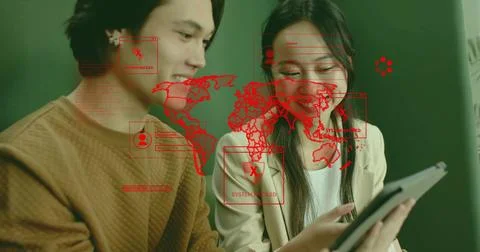 IT colleagues examining tablet screen in office with red map overlay and SYSTEM Stock Photos