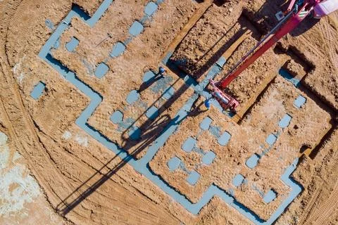 It is common during construction that an automatic pump is used to direct cement Stock Photos