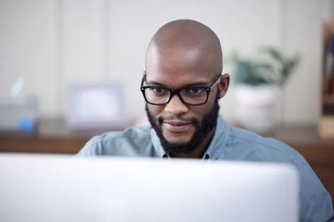 IT, computer and black man work on business software, coding or email in office Stock Photos