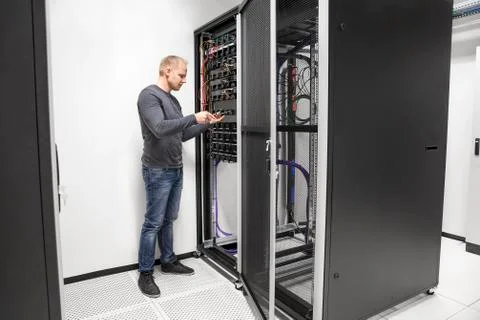 IT consultant building network rack in datacenter Stock Photos