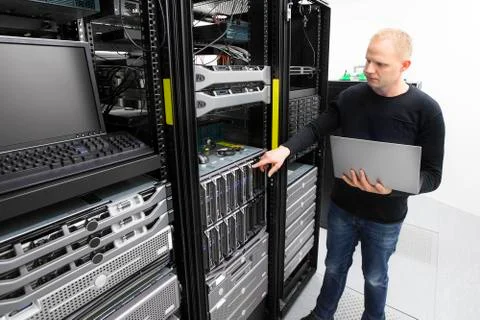 It consultant monitors blade servers in datacenter Stock Photos