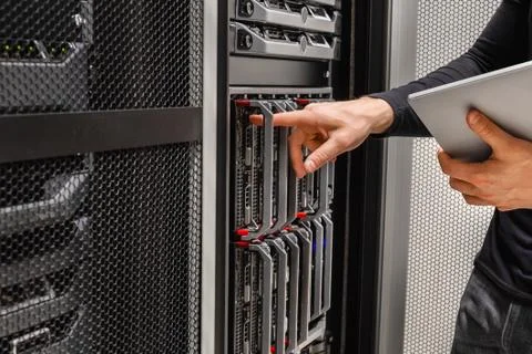 IT Consultant Using Digital Tablet Troubleshoot Problems with Server Stock Photos