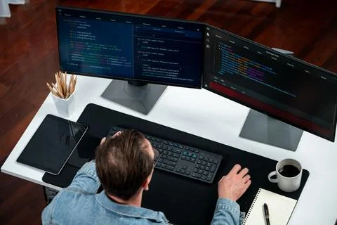 IT developer analyzing code online software development information. Sellable. Stockfoto's