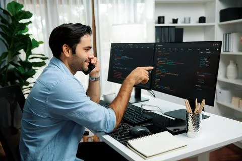 IT developer calling to coworker solving problem coding system on pc. Surmise. Foto stock