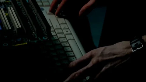 IT developer coding some software at old retro PC in dark room sloe-up Stock Footage 105465810