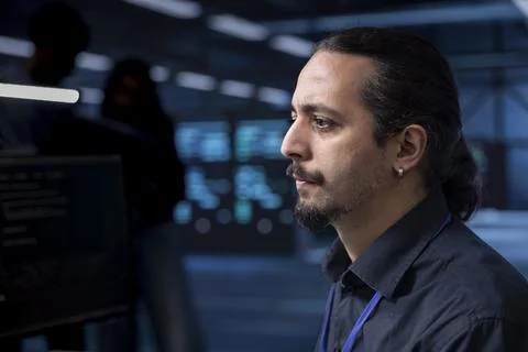 IT developer in data center updating systems to protect servers Stock Photos
