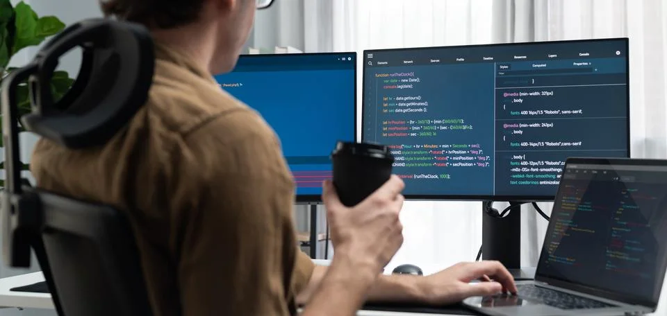 IT developer drinking coffee while working in creating program codding. Gusher. Stock Photos