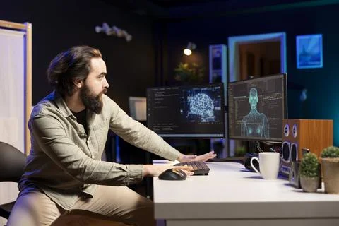IT developer frightened by self aware artificial intelligence, running from desk Stock Photos