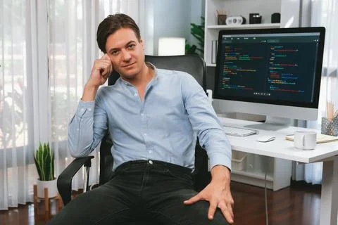 IT developer looking camera with online software development. Pecuniary. Stock Photos