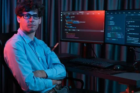 IT developer looking at camera with software development information. Gusher. 库存照片