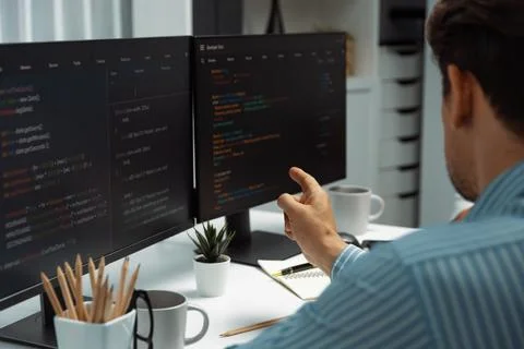 IT developer man pointing information center on laptop at back side. Postulate. Stock Photos