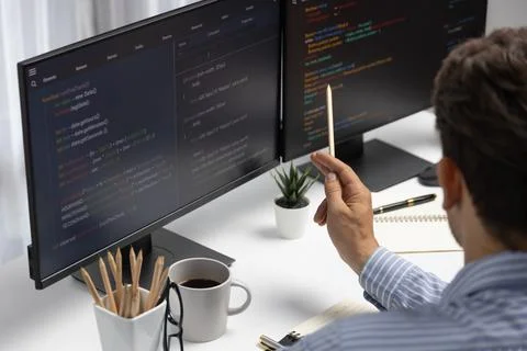 IT developer man pointing information center on laptop at back side. Postulate. 스톡 사진