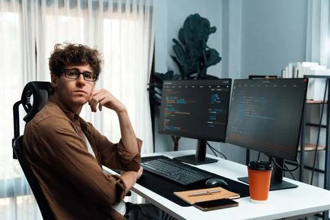 IT developer in online software information looking at camera. Gusher. Stock Photos
