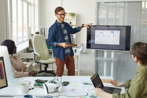 IT Developer Presenting at Team Meeting Stock Photos