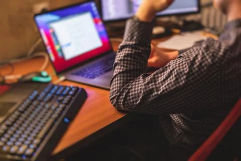 IT developer programmer working and coding on his worplace at home, laptop an Foto stock