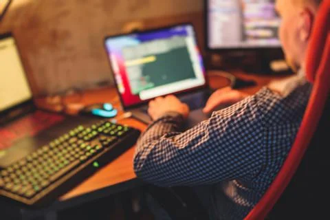 IT developer programmer working and coding on his worplace at home, laptop an Foto stock