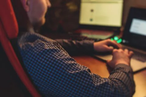 IT developer programmer working and coding on his worplace at home, laptop an Stock Photos