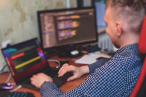 IT developer programmer working and coding on his worplace at home, laptop an Stock Photos