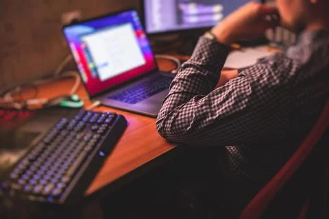 IT developer programmer working and coding on his worplace at home, laptop an Stockfoto's