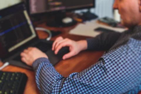 IT developer programmer working and coding on his worplace at home, laptop an Foto stock