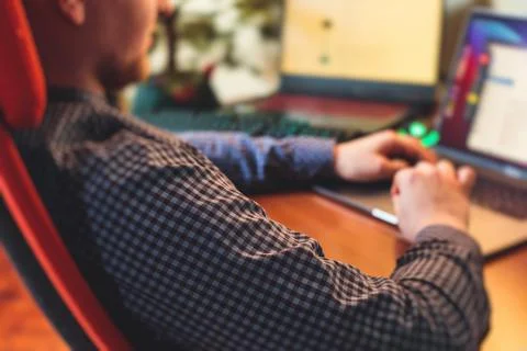 IT developer programmer working and coding on his worplace at home, laptop an Stockfoto's