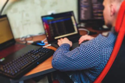 IT developer programmer working and coding on his worplace at home, laptop an Stock Photos