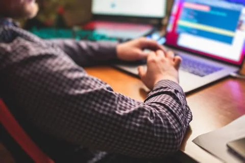 IT developer programmer working and coding on his worplace at home, laptop an 库存照片