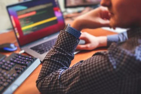 IT developer programmer working and coding on his worplace at home, laptop an Stock Photos