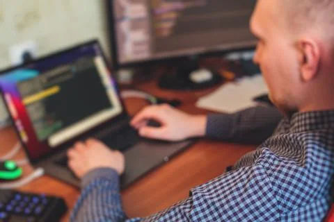 IT developer programmer working and coding on his worplace at home, laptop an 写真素材