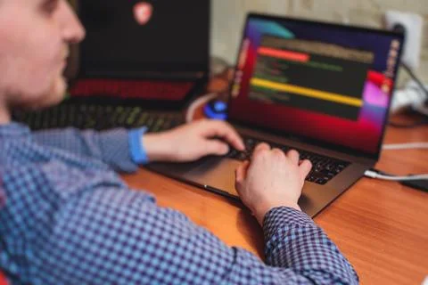 IT developer programmer working and coding on his worplace at home, laptop an Foto stock