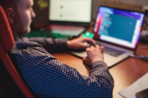 IT developer programmer working and coding on his worplace at home, laptop an Foto stock