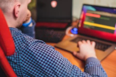 IT developer programmer working and coding on his worplace at home, laptop an Foto stock