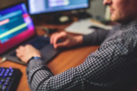 IT developer programmer working and coding on his worplace at home, laptop an Foto stock
