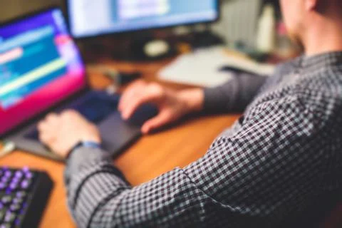 IT developer programmer working and coding on his worplace at home, laptop an 写真素材