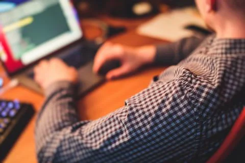 IT developer programmer working and coding on his worplace at home, laptop an Stock Photos