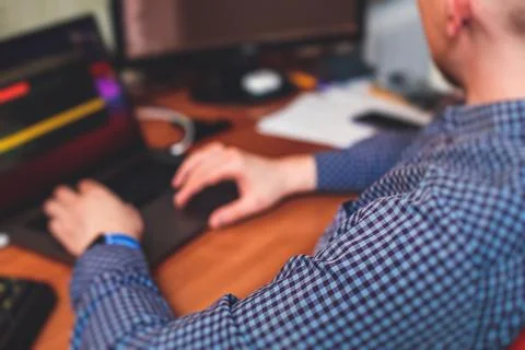 IT developer programmer working and coding on his worplace at home, laptop an Foto stock