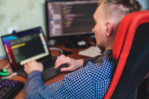 IT developer programmer working and coding on his worplace at home, laptop an Foto stock